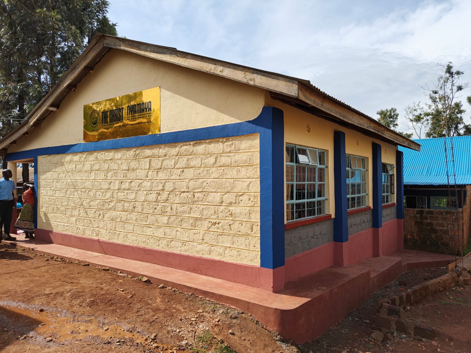 Classroom block with gold plaque and blue trim