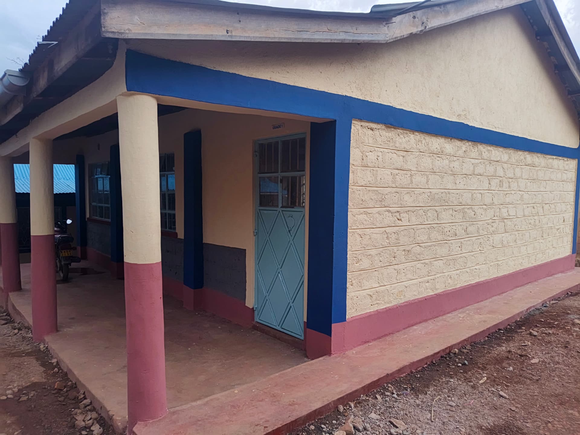 Grade 1 veranda with painted pillars, blue door and maroon plinth