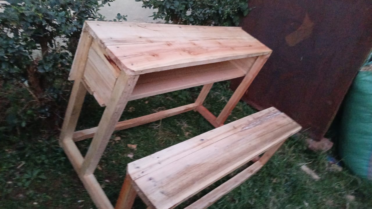 Finished desk and bench set standing outside the workshop