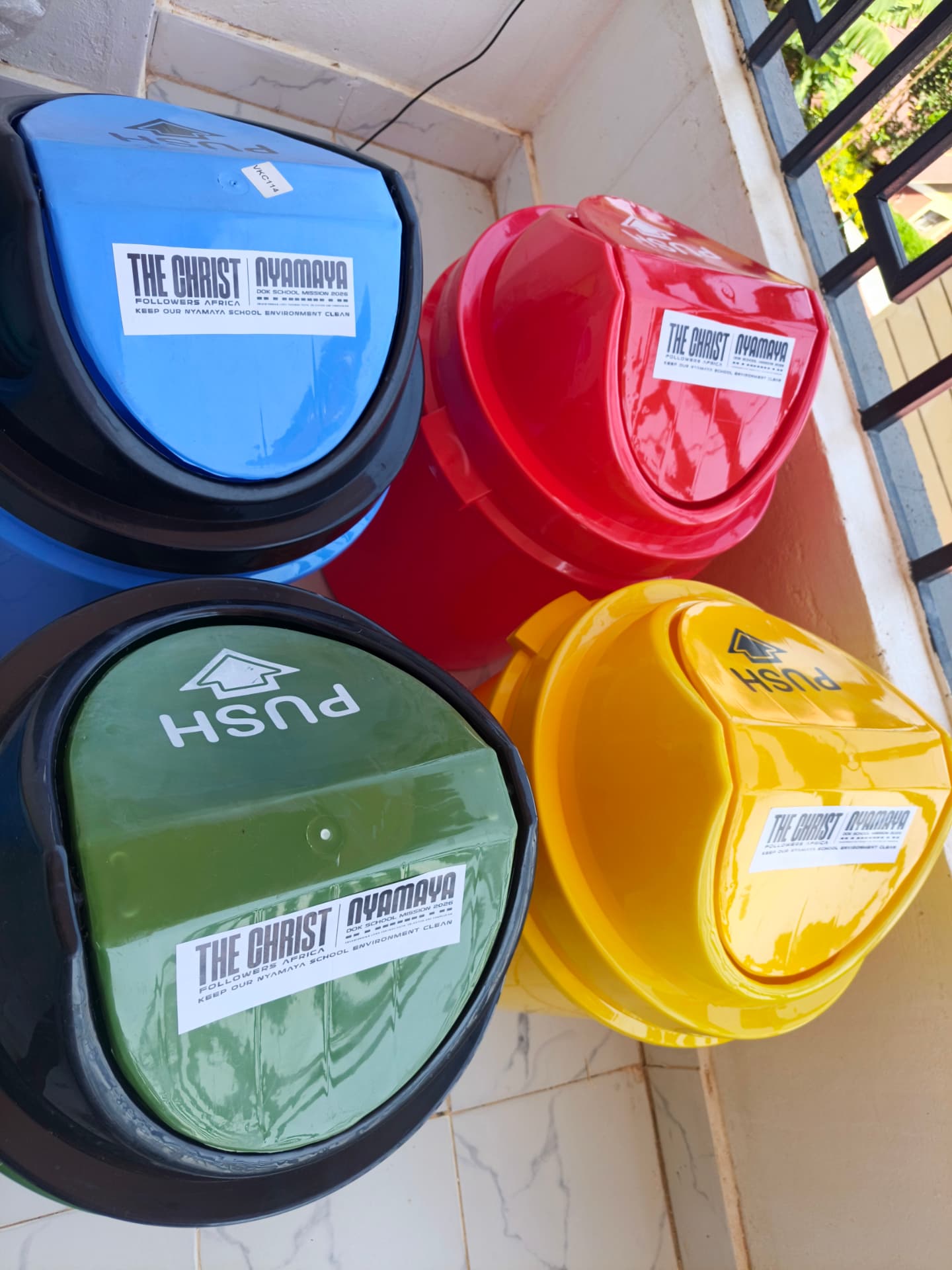 Green, yellow, blue and red bins stacked and ready for placement