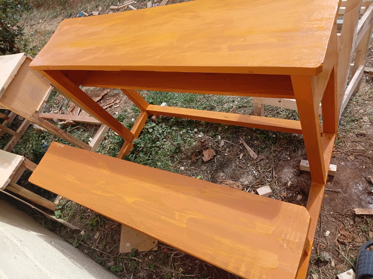 Finished school desk with attached bench in bright wood finish