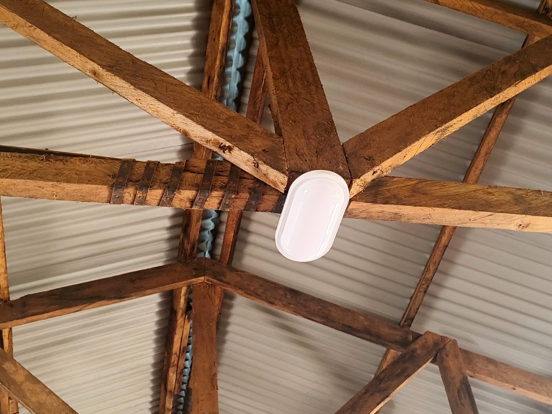 Close-up of the new ceiling light mounted on the wooden truss
