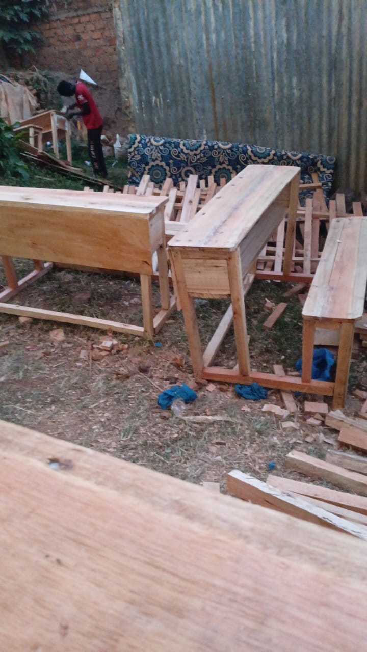 Carpenter assembling new desks and benches at the workshop