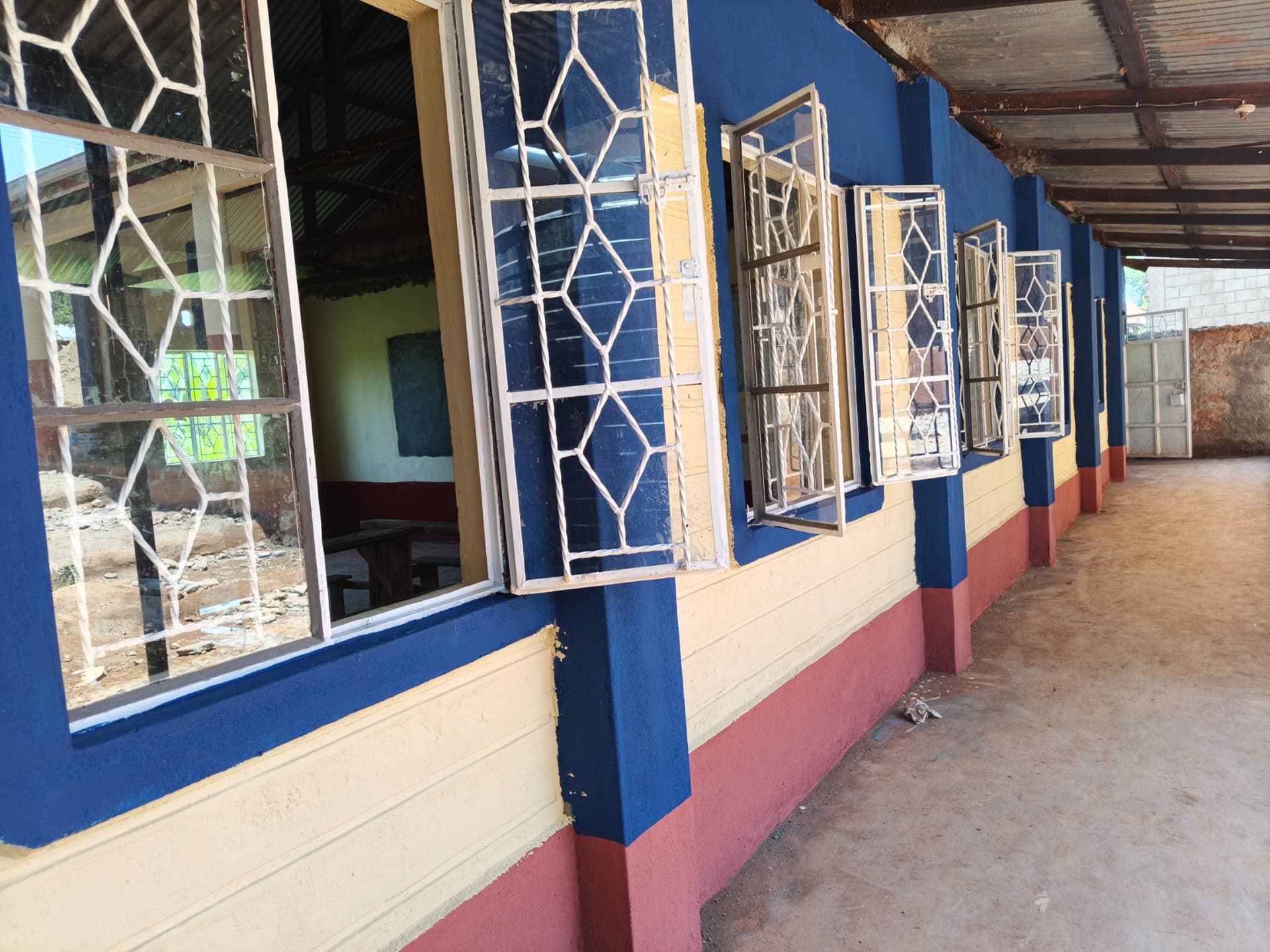 Repainted veranda with refurbished window frames open along the corridor