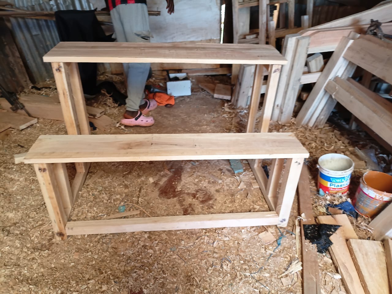 Two finished desk and bench units in the workshop