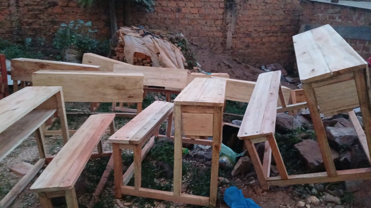 Batch of newly built wooden desks and benches ready for the school