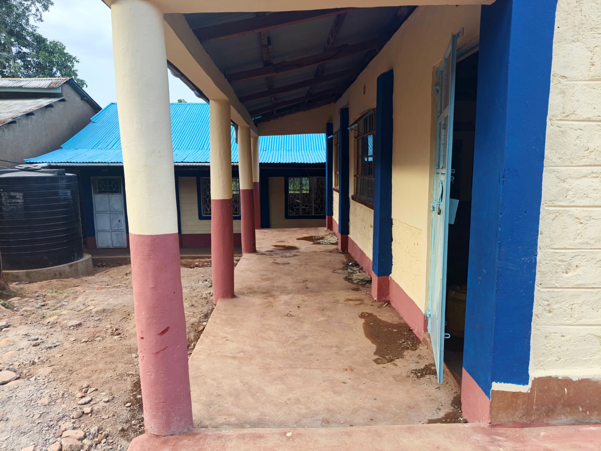 Finished walkway between classroom blocks with painted pillars