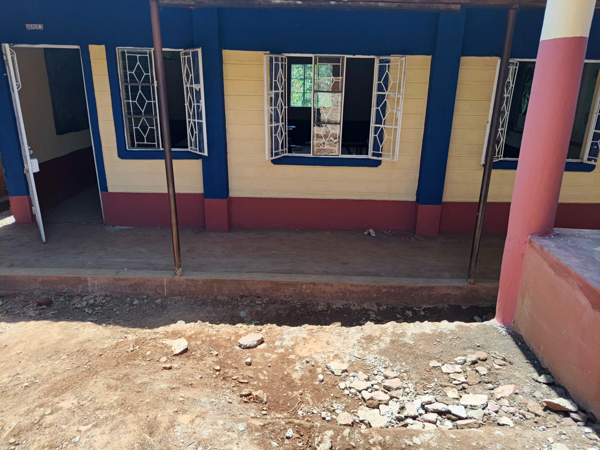 Grade 3 classroom exterior freshly painted blue, cream and maroon