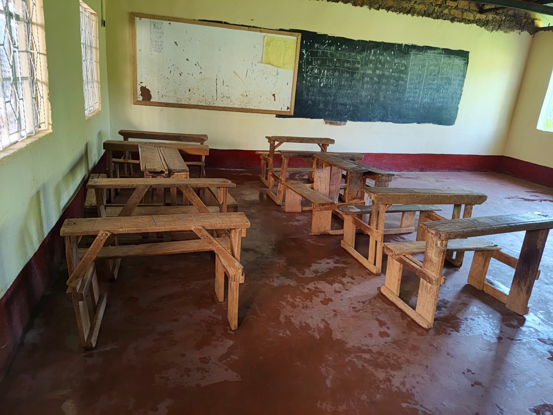 Classroom with old worn wooden benches and desks